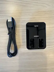 black signia inductive charger with charging cord on desk