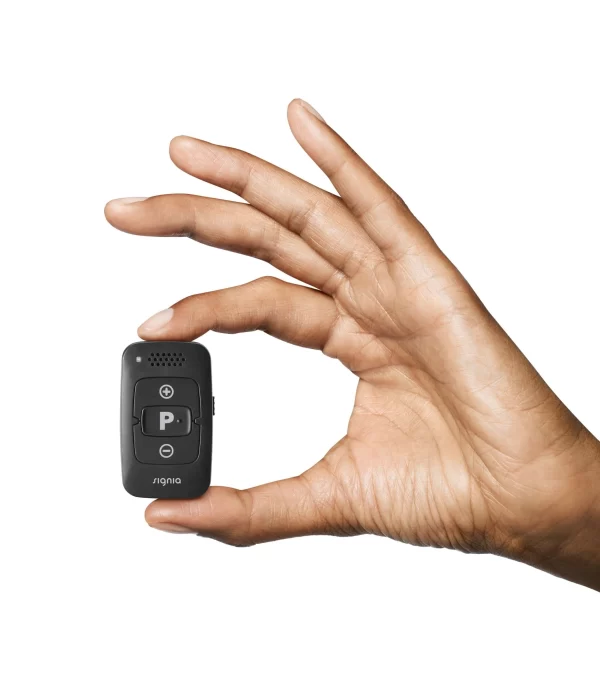 hand holding rexton smart key remote small discreet hearing aid remote control