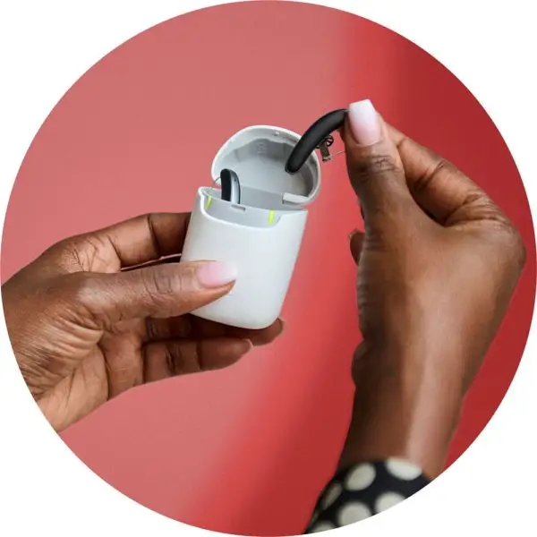 woman taking styletto ix hearing aids out of charging case