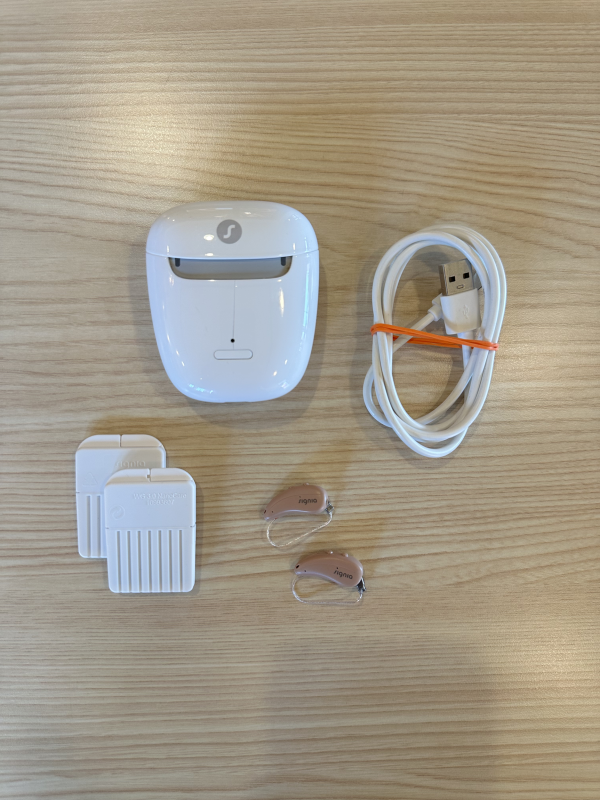 used signia 7ix hearing aids with charger, cord, and wax guards