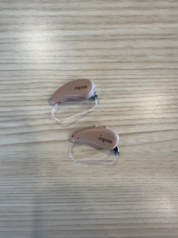 used signia 7ix hearing aids in beige just aids on table