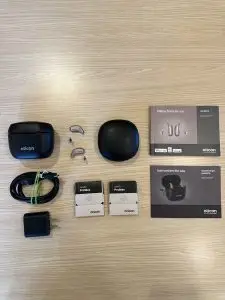 used oticon intent 1 listing with premium charger, cable, wall plug, hard case, wax guards, charger and hearing aid manuals, and hearing aids